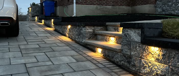 A New Jersey home with a paver pathway and lights