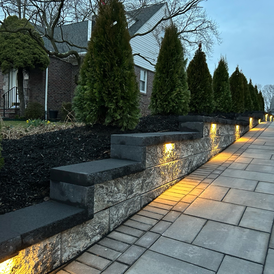 Outdoor retaining wall with LED lighting along a pathway